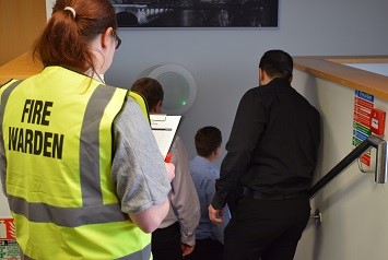 Fire marshal guiding participants during a fire safety drill